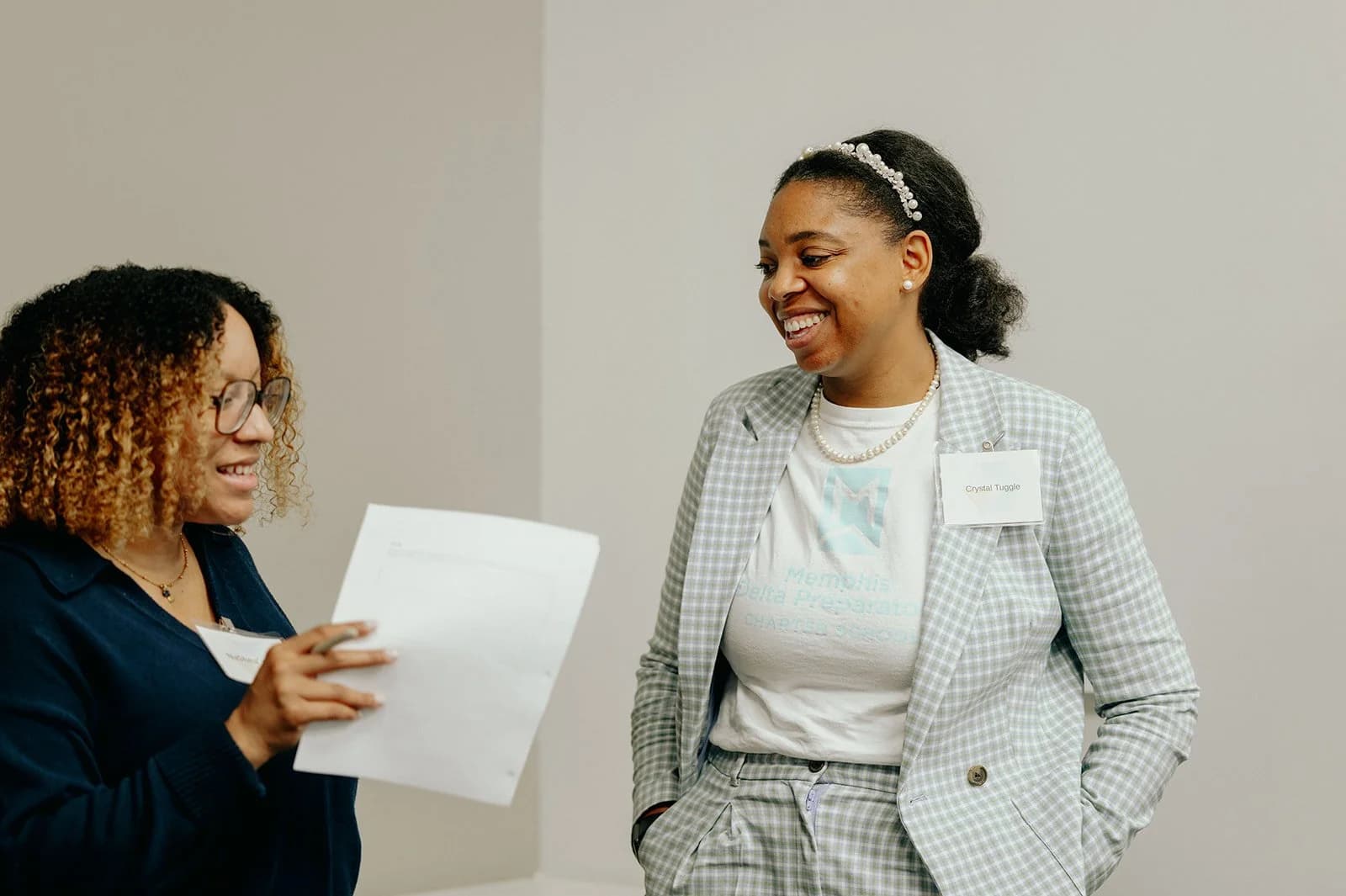 Two school leaders sharing a light moment during a PIVOT leadership development workshop
